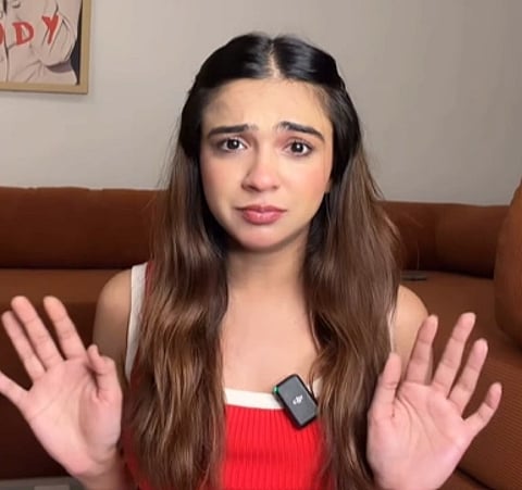 Image of Apoorva Mukhija aka the rebel kid talking in an instagram video. she is sitting on a bed and narrating her flight experience.