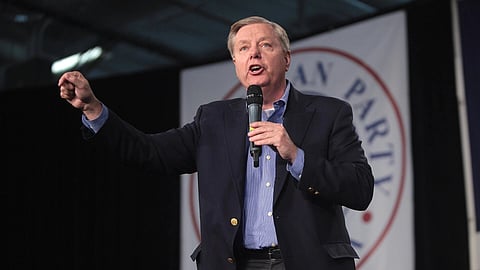 In the image Lindsey Graham is shown. U.S. Senator Lindsey Graham speaking with attendees at the 2015 Iowa Growth & Opportunity Party at the Varied Industries Building at the Iowa State Fairgrounds in Des Moines, Iowa.
