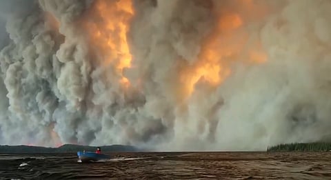 Smoke rises from an active wildfire in Ontario, Canada, as extreme wildfire conditions fuel the country's climate emergency