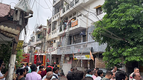 Photo of Fire department working to douse the fire that broke out at a residential building in B K Dutt Colony