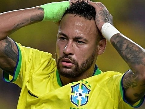 Famous Brazil football player Neymar in his official jersey' in the image he is seen in shock with both of his hands placed on his head.