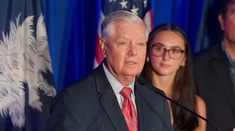 In the image Lindsey Graham is shown adressing the people in a official gathering