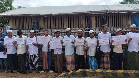 In the image Refugee are shown outside the UNHCR office standing in peaceful protest