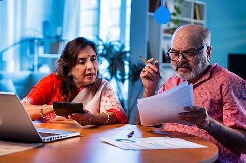an image of a old couple checking their finances and documents.