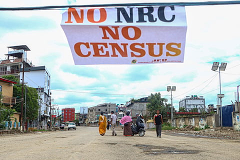 A No NRC No Census paper in a wire and a view of Manipur