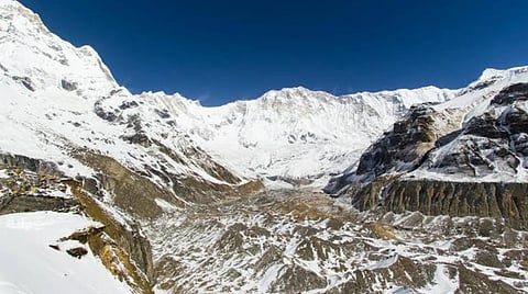 Trekkers on the Everest Base Camp trail with Himalayan peaks in the background