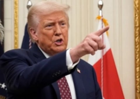 Image of trump pointing his finger towards something.