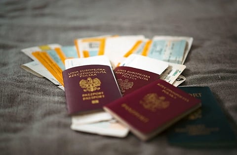 Indian passport, Schengen visa file and boarding pass laid out before a Europe trip