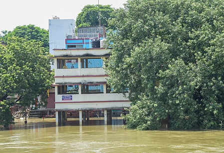 A multi-stored Building semi-submerged under flood water.