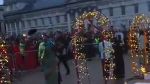In the image a UK building is shown and a decoration is shown on the bankof river thames