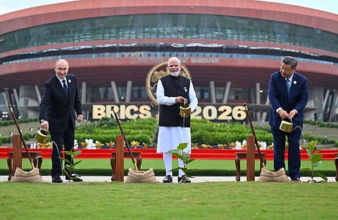Image of Russian president Vladimir Putin (left) PM Modi (centre) President Xi Jingpin (right) watering plants at the BRICS 2026 summit