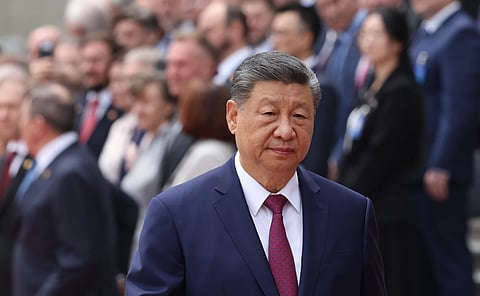 A man looking at the camera wearing a blue suit.