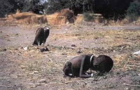 The Image is from 1993 Sudan Famine where Kevin carter took a photo of a famine stricken little girl who fell to the ground and is stalked by a hooded vulture.