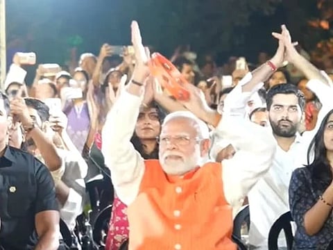 Image of PM Modi vibing to a bhajan clubbing event in delhi on September 25, 2026. in the image PM Modi is singing and playing a tambourine