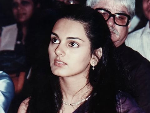 Image of flight attendant and model Neerja Bhanot sitting in a event.