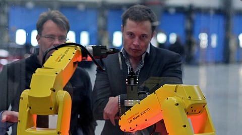 Elon musk watching a robot perform its functions