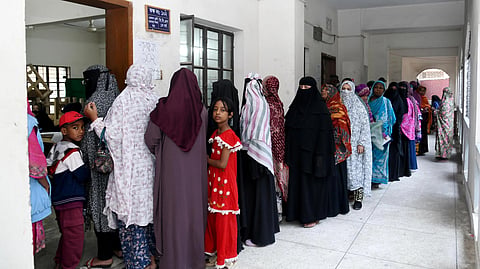 women in Bangladesh standing in queue of government office