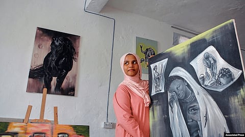 Somali artist Sana Ashraf Sharif Muhsin, 21, displays some of her drawings at her home in the capital Mogadishu, Somalia, Oct. 15, 2021    Image credit: VOA
