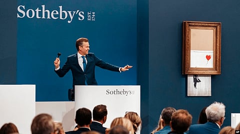 Sotheby's received some criticism at the time for failing to spot the hidden shredder. But the 2018 buyer decided to go through with the purchase, a decision that was vindicated on Thursday as the work's price soared. Image source: voa