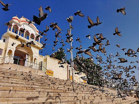 The temple, which is situated on a high platform, is accessible by a series of stairs.