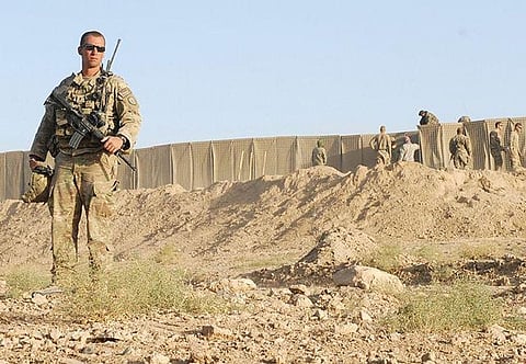 Troops keep a watchful eye on the perimeter of the U.S. Consulate in Herat, Afghanistan a day after it was attacked by the Taliban incurring heavy damage.