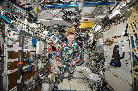 NASA Astronaut Kate Rubins wears Spacesuit Painted by Kids With Cancer to raise awareness about benefits of pairing Art with Medicine