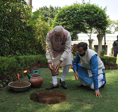 Candid pictures of PM Narendra Modi and Prakash Javadeker while planting a ‘Kadamb’ sapling