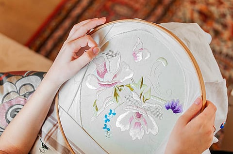 Hand embroidered flower motif.