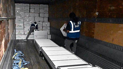The first boxes of the Johnson & Johnson COVID-19 vaccine are loaded into a truck for shipment from the McKesson facility in Shepherdsville, Ky., March 1, 2021. (VOA via AP)