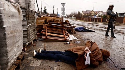 The body of a person, with hands tied behind his or her back, lies in a street, amid Russia's invasion on Ukraine, in Bucha, near Kyiv, April 3, 2022. According to local residents, the person was shot by retreating Russian soldiers. (VOA via Reuters)