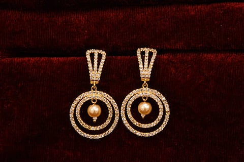 Fancy Designer Golden earrings pair for woman fashion (Unplash)