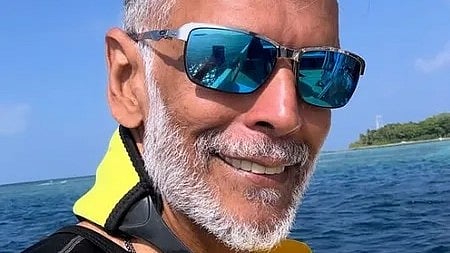 समुद्र में नाव में बैठे एक आदमी की तस्वीर|