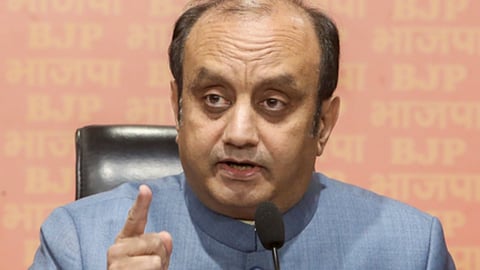 नीले रंग की सूट में भाजपा प्रवक्ता सुधांशु त्रिवेदी, माइक के सामने हैं और ऊँगली उठाकर कुछ बोलने का इशारा कर रहे हैं।