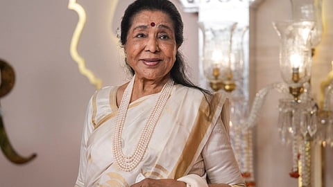 सफ़ेद साड़ी में आशा भोसले की तस्वीर