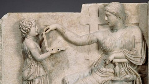 Ancient Greek Statue Of Woman Holding 'Laptop' ?