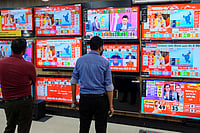 Day In Pics: October 08, 2024 | Photo: PTI : Assembly election results day: People at TV showroom
