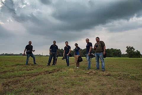 The members of Kolkata Cloud Chasers pose with a cloud formation