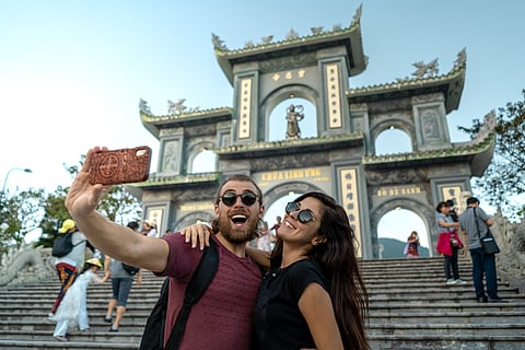Happy tourist couple taking a selfie in Da Nang Vietnam