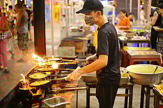 A Vietnamese chef preparing Rice Flour Pan Cake, a popular vegetarian dish