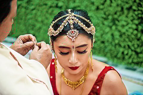 Reena Ahanthem's relative weaves in the jhappa (bridal head gear)