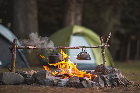 Campfire in front of tents