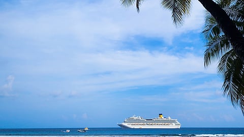 The ship glides through the gentle waves in the sea