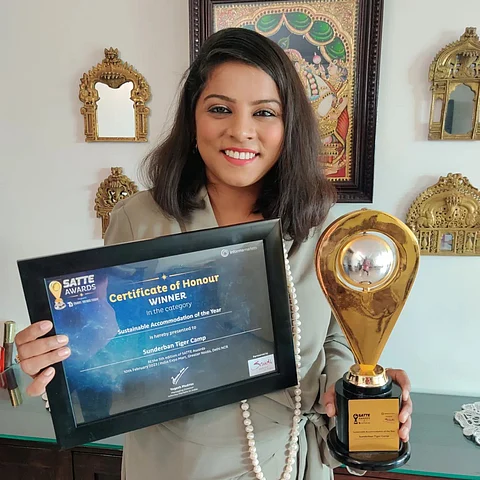 Akanksha Garg posing with the sustainable accommodation award given to the Sunderban Tiger Camp by South Asia's Travel and Tourism Exchange (SATTE)