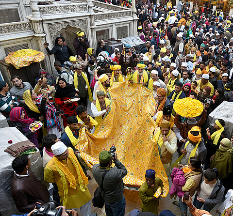 People carry the sheet (chadar) to be offered at the dargah of the great Sufi, Nizamuddin Auliya