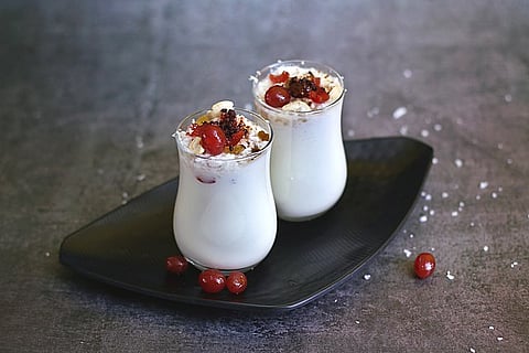 Yogurt-based lassi prepared in Odia style. It is topped with grated coconut, cherry, cashew nuts and raisins