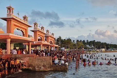 Pilgrims at a theertham in Rameswaram