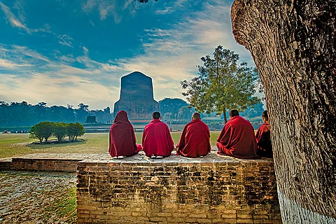 Buddhist monks in prayer near the Sarnath Stupa in Varanasi, Uttar Pradesh