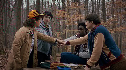 A still from Stranger Things 5 showing Will, Mike, Dustin, and Lucas, filming locations