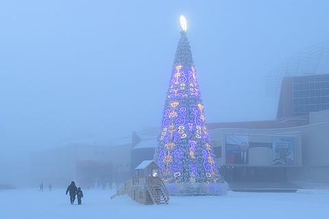 Winter cityscape in Yakutsk with a festive tree decorated with traditional Yakut ornaments