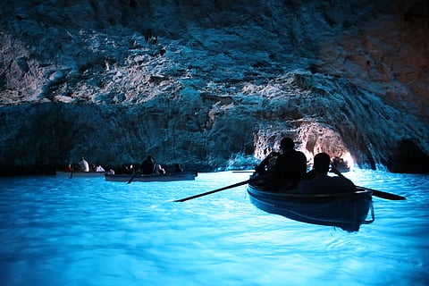 The Blue Grotto Sea Cave is filled with electric blue light